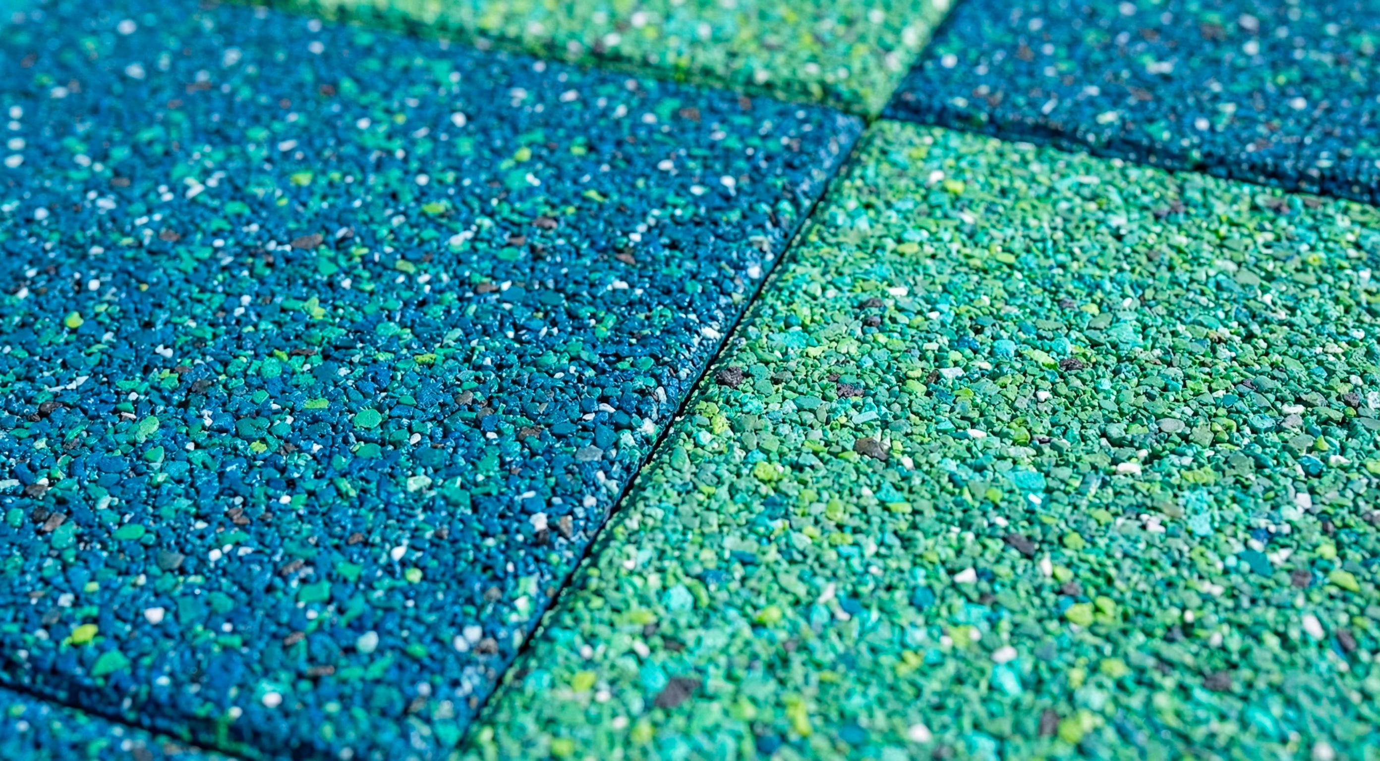 Vibrant blue and green EPDM rubber tile surface close-up